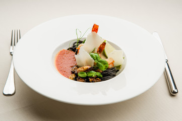 Black spaghetti with seafood,parmesan and tomato sauce