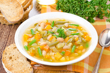 plate of vegetable minestrone with white beans and toast