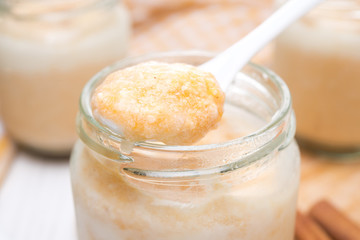 spoon of yogurt with spiced pumpkin puree, close-up