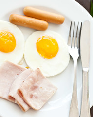 fried eggs with bacon and sausages
