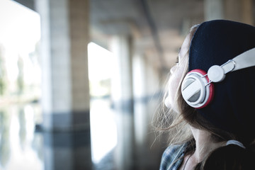 beautiful young blonde hipster woman listening music