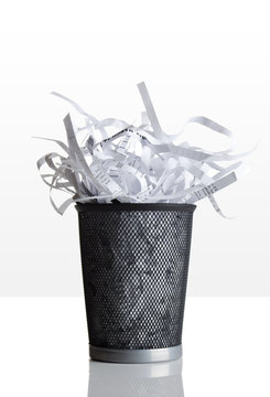 Trashcan full of shredded paper