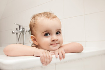 Little girl sitting in bathtub