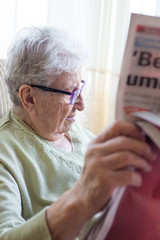 senior person reading newspaper