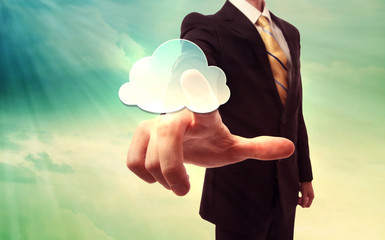 Businessman pressing a cloud computing icon