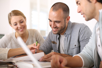 Young people in college studying together in library