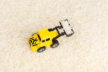 Industrial tractor toy on the rice grains