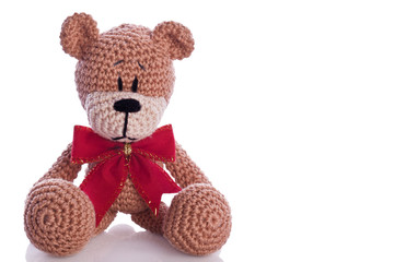 christmas teddy bear with red ribbon as a gift