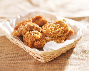 fried chicken pieces in a basket