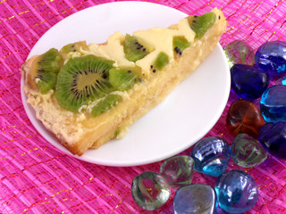 kiwi tasty cake close up at plate with stones set