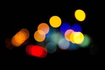 Abstract background with colorful lights bokeh on black