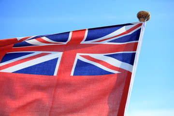 British maritime red ensign flag blue sky