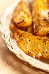 Portion of fresh Potato Wedges With Parmesan