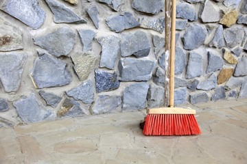 large broom on wall outdoor - housework