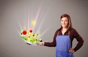 Young woman cooking fresh vegetables