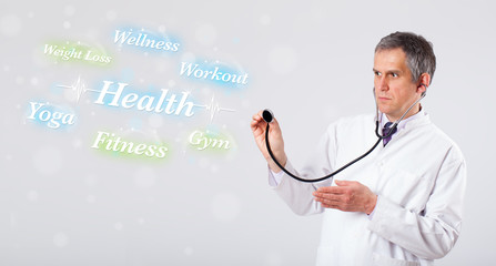 Clinical doctor pointing to health and fitness collection of wor