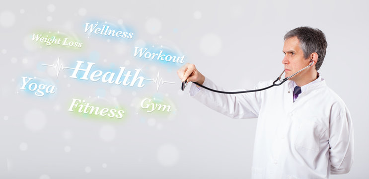 Clinical doctor pointing to health and fitness collection of wor