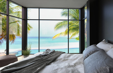 Tropical bedroom interior with double bed and seascape view