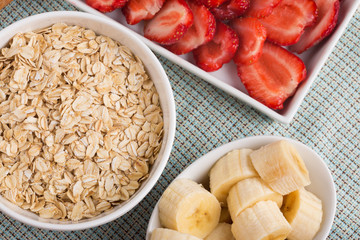 Oat flakes in bowl with banana and strawberry