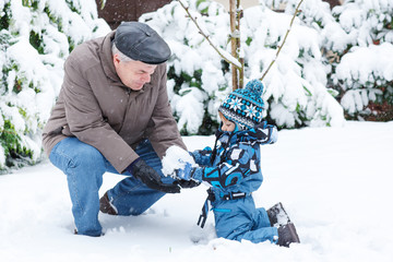 Grandfather and toddler boy  on winter day