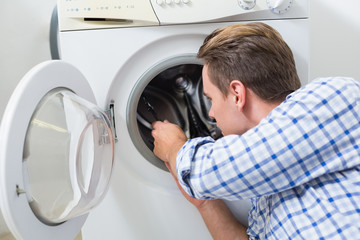 Technician repairing a washing machine