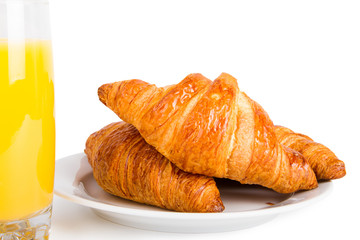 Croissants and glass of orange juice