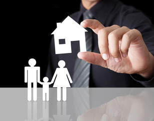 Man hand holding paper house with family, Insurance concept