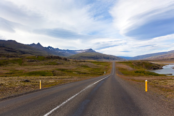 Highway through Iceland landscape at overcast day