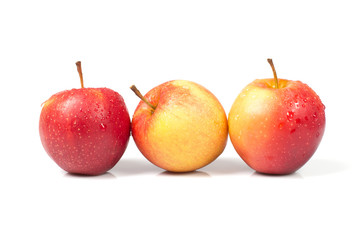 three isolated apples with water drops