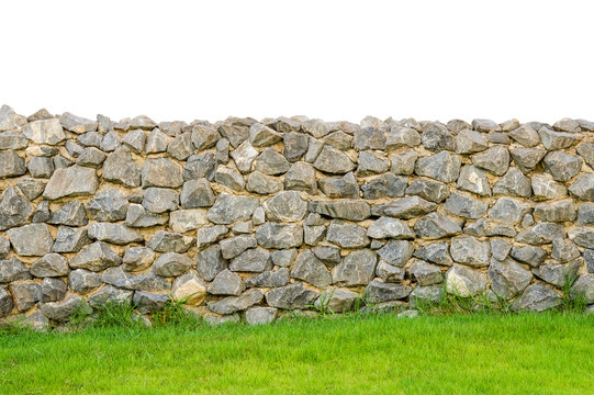 fence real stone wall surface with cement on green grass field