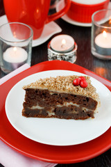 Fototapeta na wymiar Cocolate cake with nuts on a red background. New Year's cake.