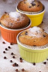 Three muffins with icing sugar