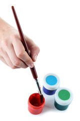 Paint brush in hand and multicolored paints isolated on white