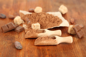 Fototapeta na wymiar Cocoa powder on wooden table