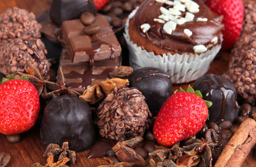 Tasty cupcake with different sweets close up