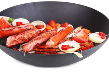 Delicious sausages in wok isolated on white