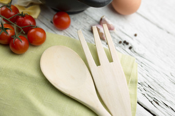 Napkin with a wooden spoon on wooden background