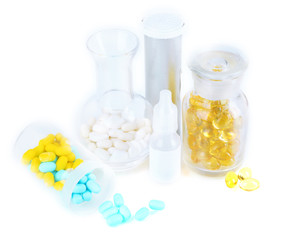 Medical bottles and pills isolated on white