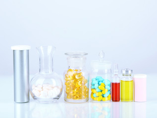 Medical bottles and pills isolated on white