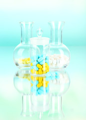 Medical pills on green background