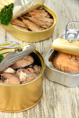 Open tin can, on wooden background