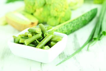 Fresh green vegetables, on wooden background
