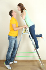 Young couple doing renovation in new house