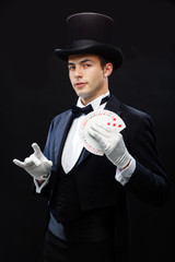 magician showing trick with playing cards