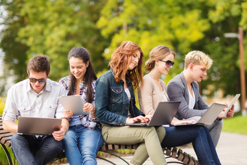 students or teenagers with laptop computers