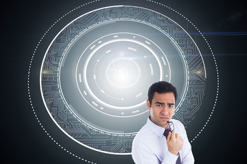 Composite image of thinking businessman holding glasses