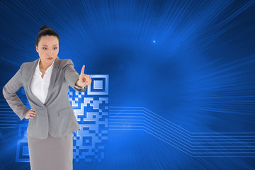 Composite image of unsmiling asian businesswoman pointing