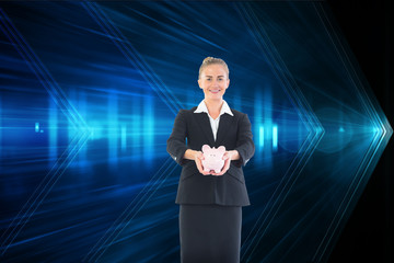 Composite image of happy businesswoman holding a piggy bank