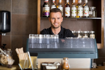 Smart Male Bartender At Counter In Cafe