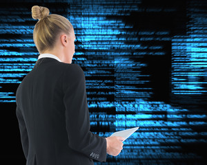 Composite image of businesswoman holding tablet